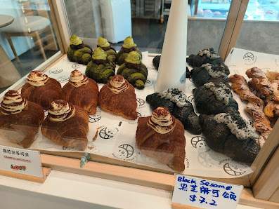 Display cabinet at Wheatz Bakery filled with pastries and cakes.