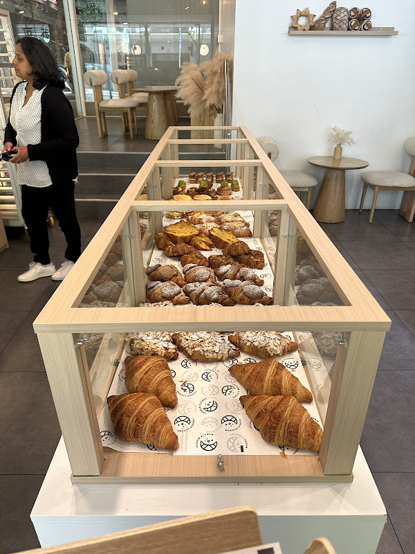 Croissants and pastries displayed inside Wheatz Bakery.